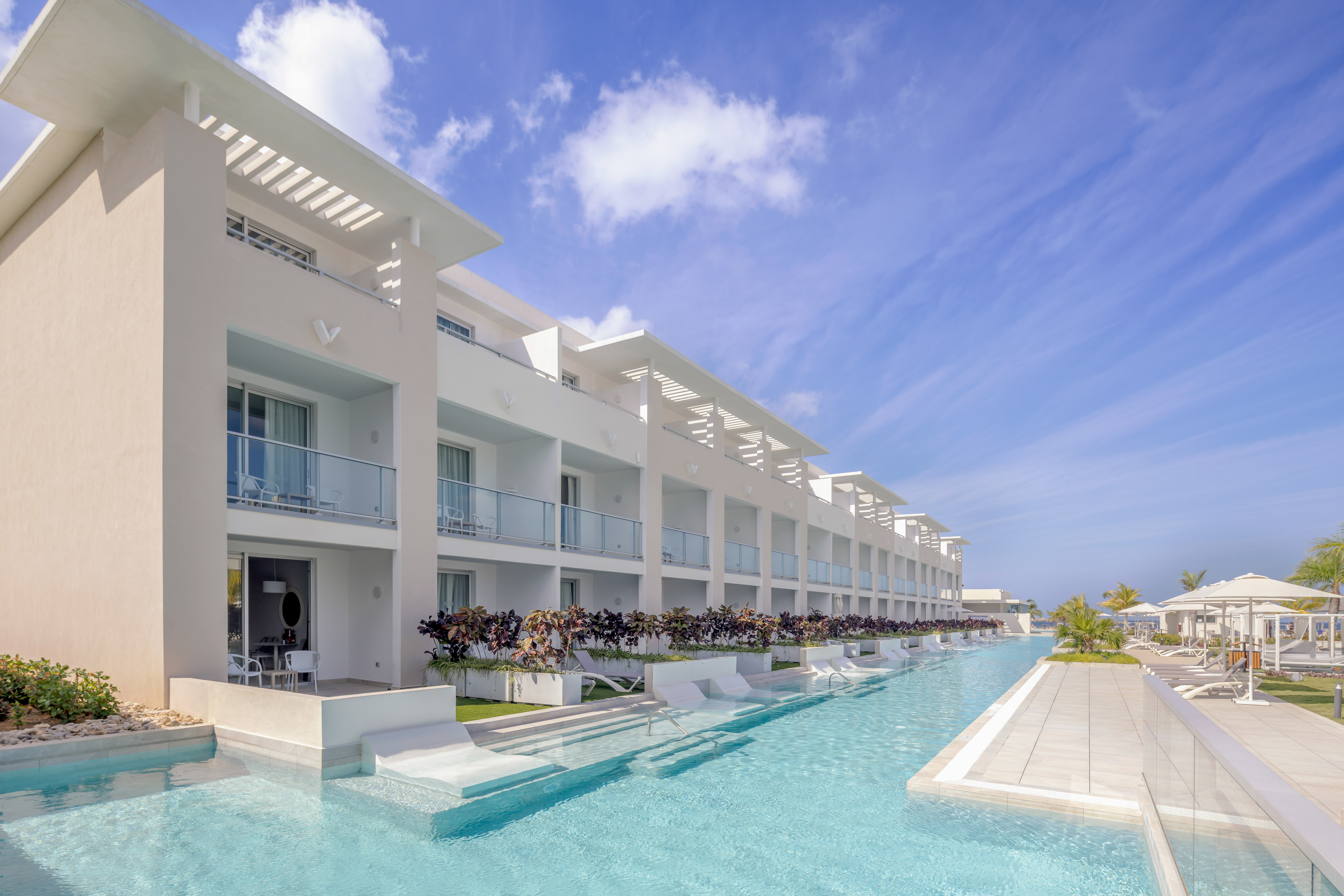 a pool with a building and a blue sky