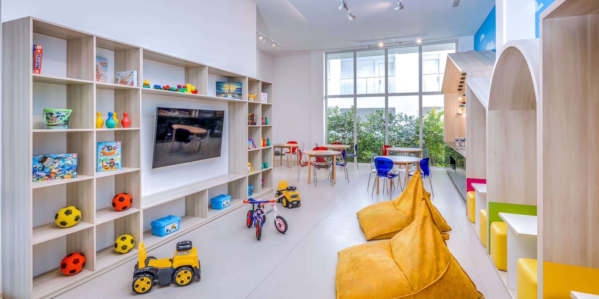 a room with a large television and toys