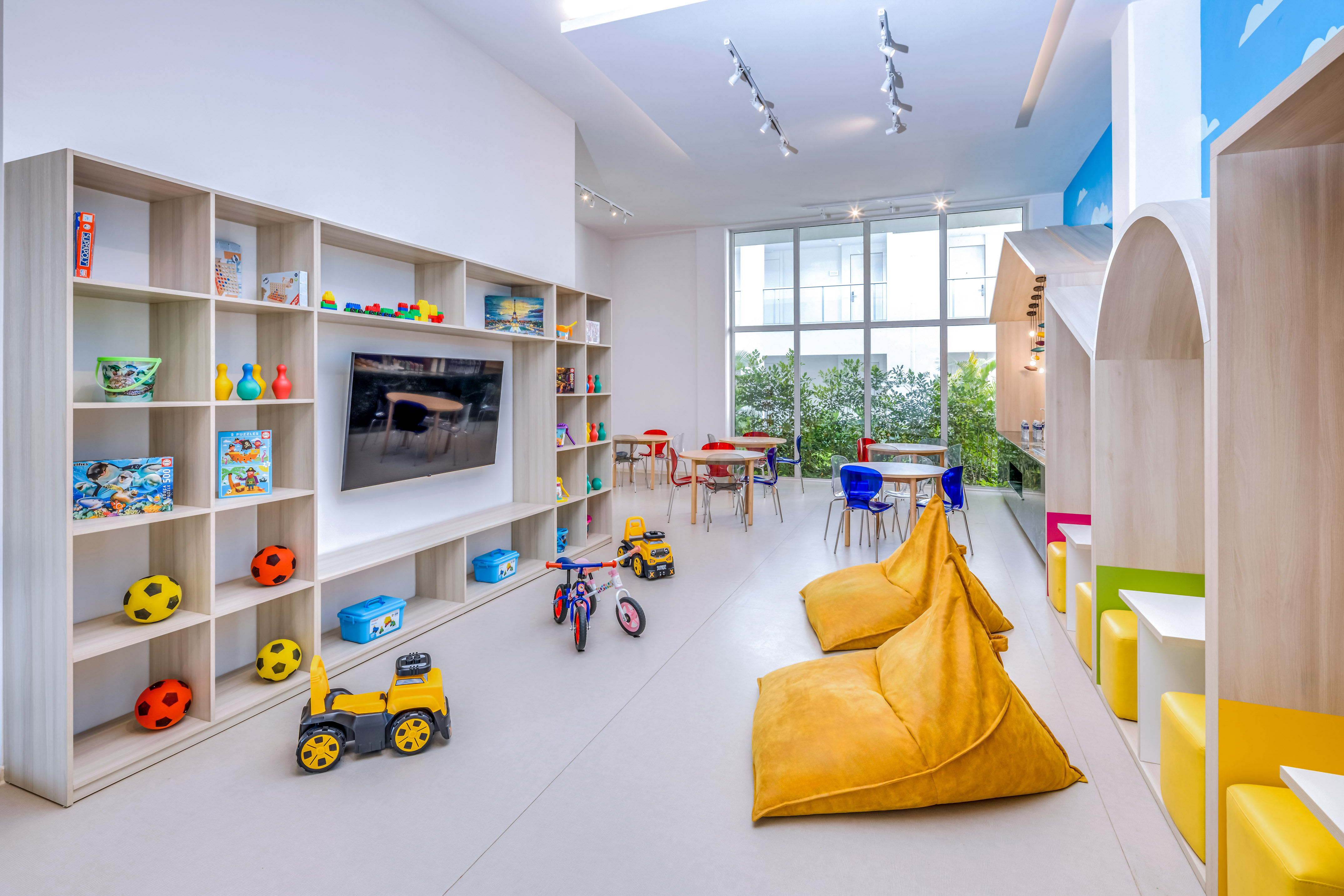 a room with a large television and toys