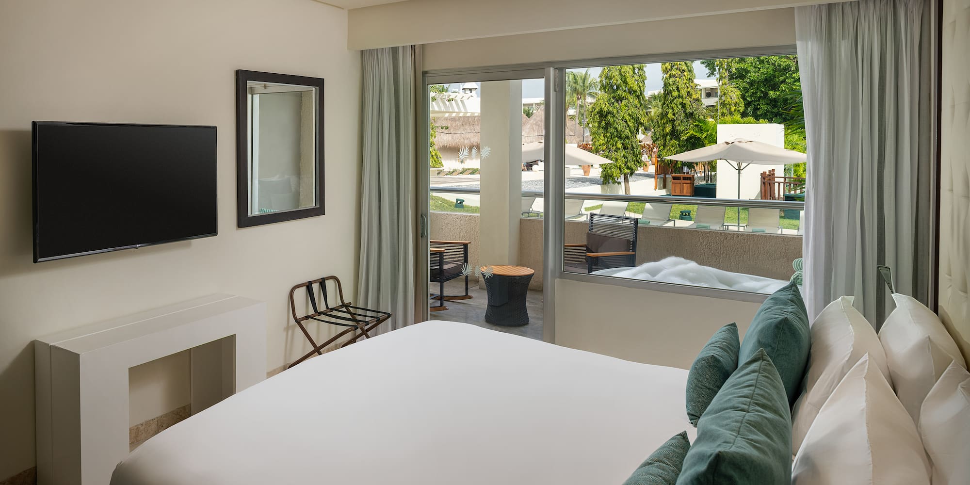 a bedroom with a bed and a television