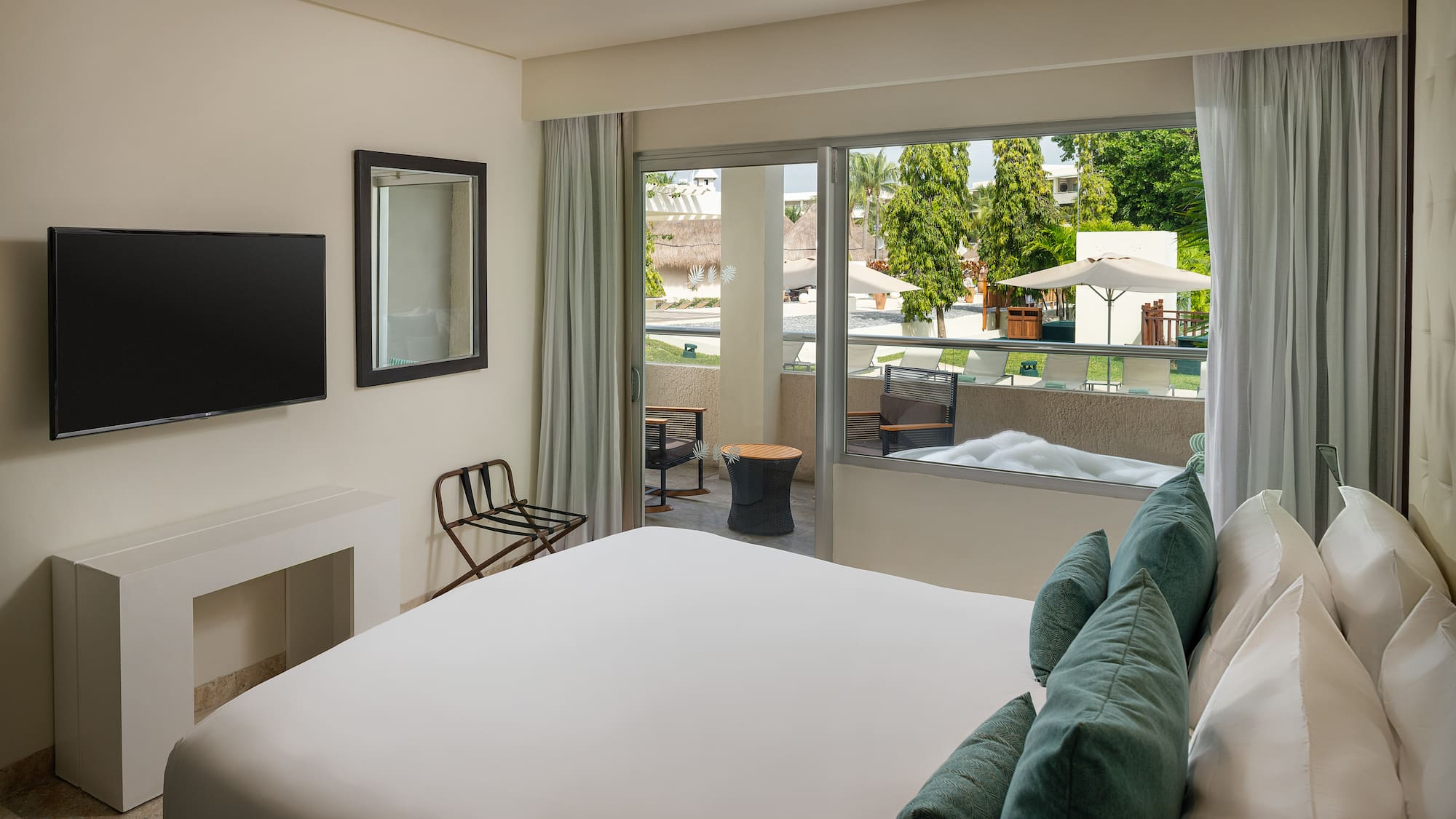 a bedroom with a bed and a television