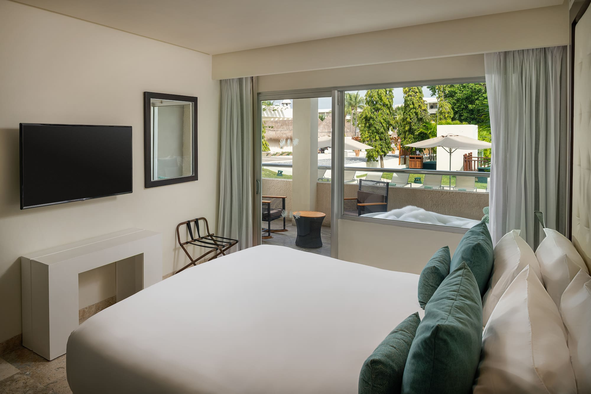 a bedroom with a bed and a television