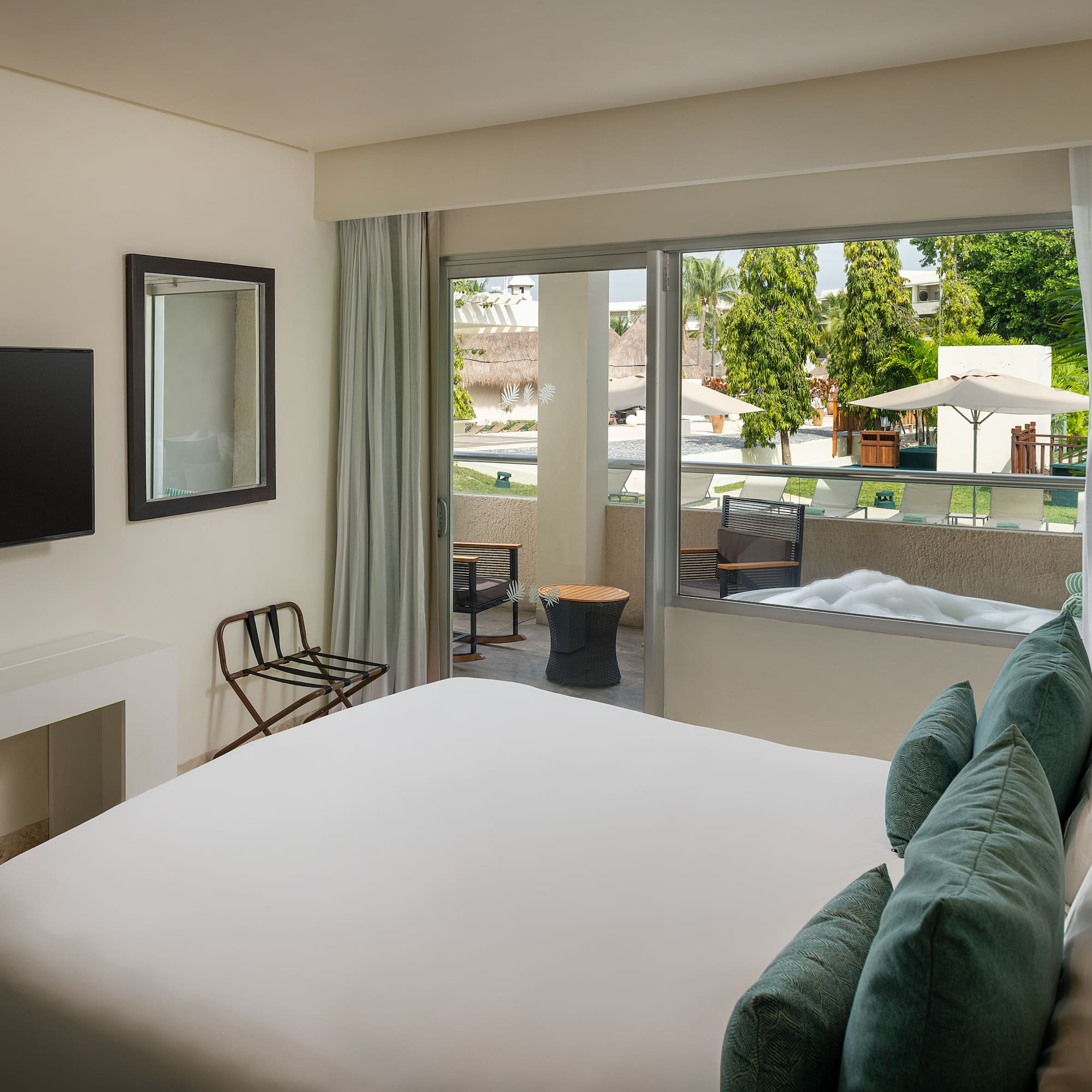 a bedroom with a bed and a television