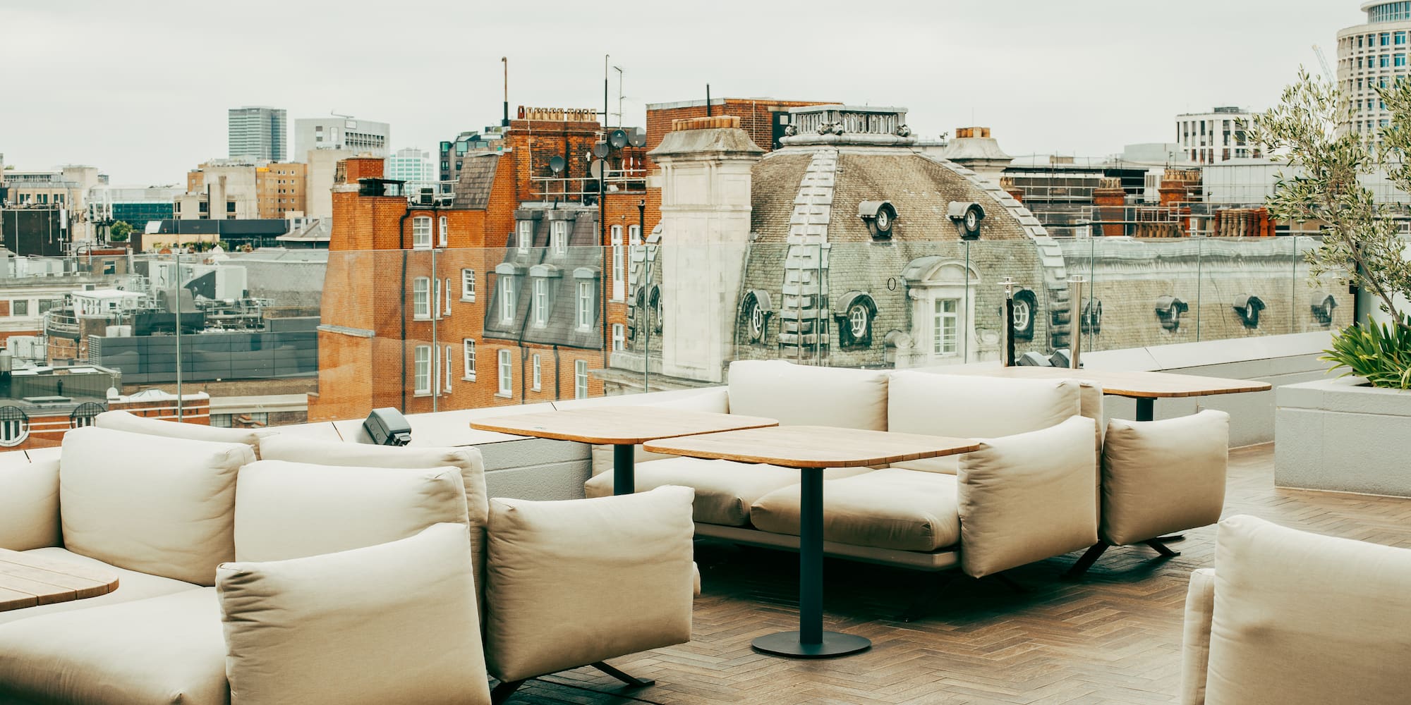 a rooftop patio with a group of couches and tables