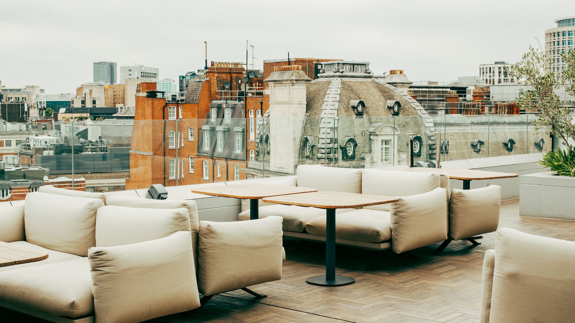 a rooftop patio with a group of couches and tables