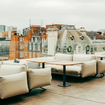 a rooftop patio with a group of couches and tables