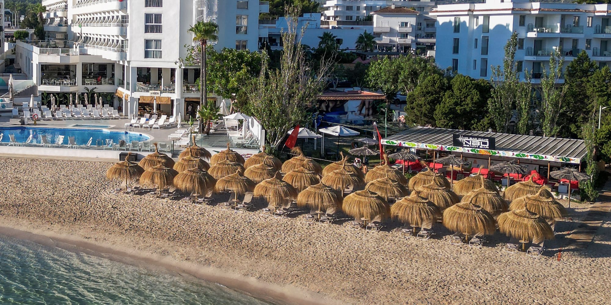 a beach with umbrellas and a body of water
