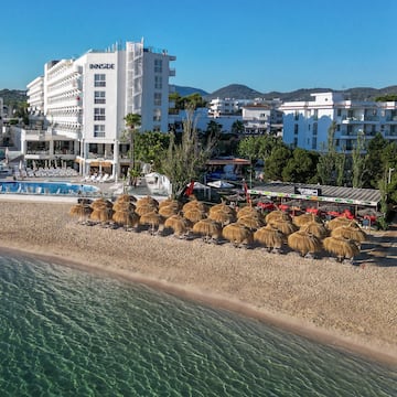 a beach with umbrellas and a body of water