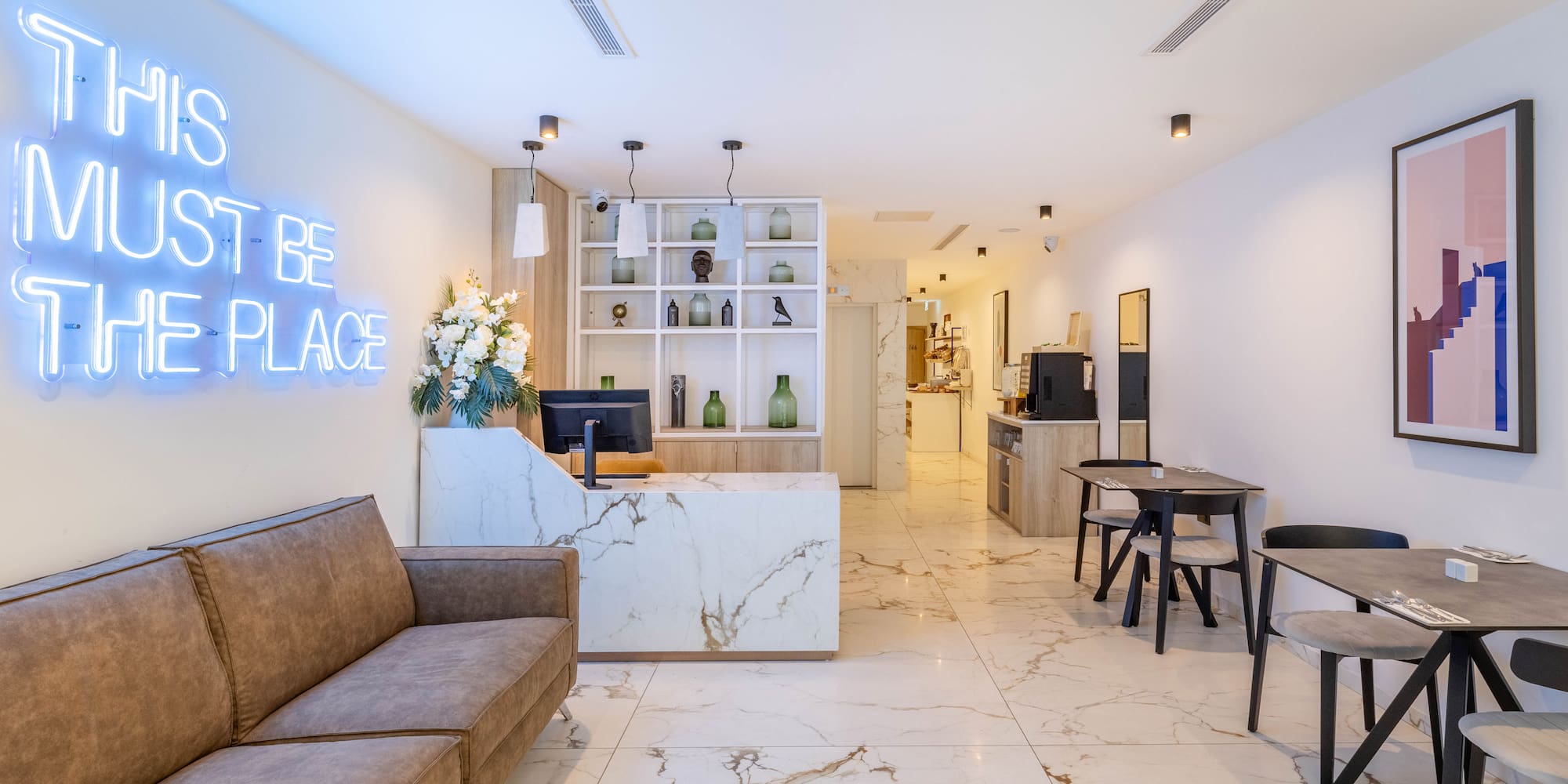 a room with a marble floor and a couch and a desk