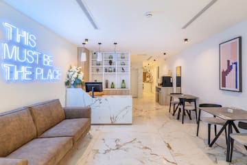a room with a marble floor and a couch and a desk