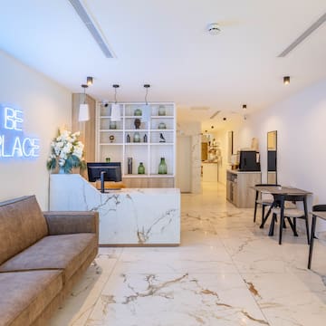 a room with a marble floor and a couch and a desk