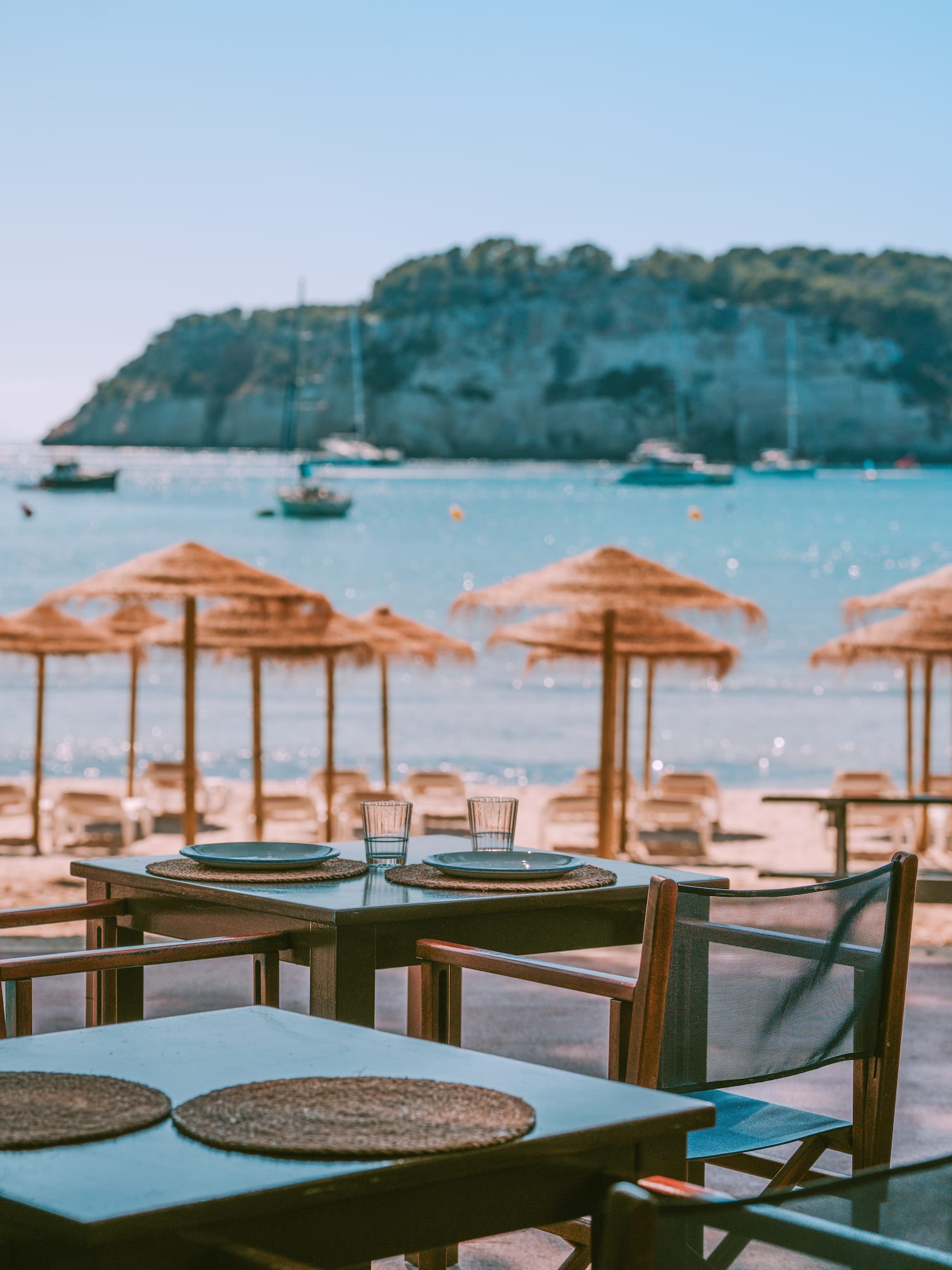 a table and chairs on a beach