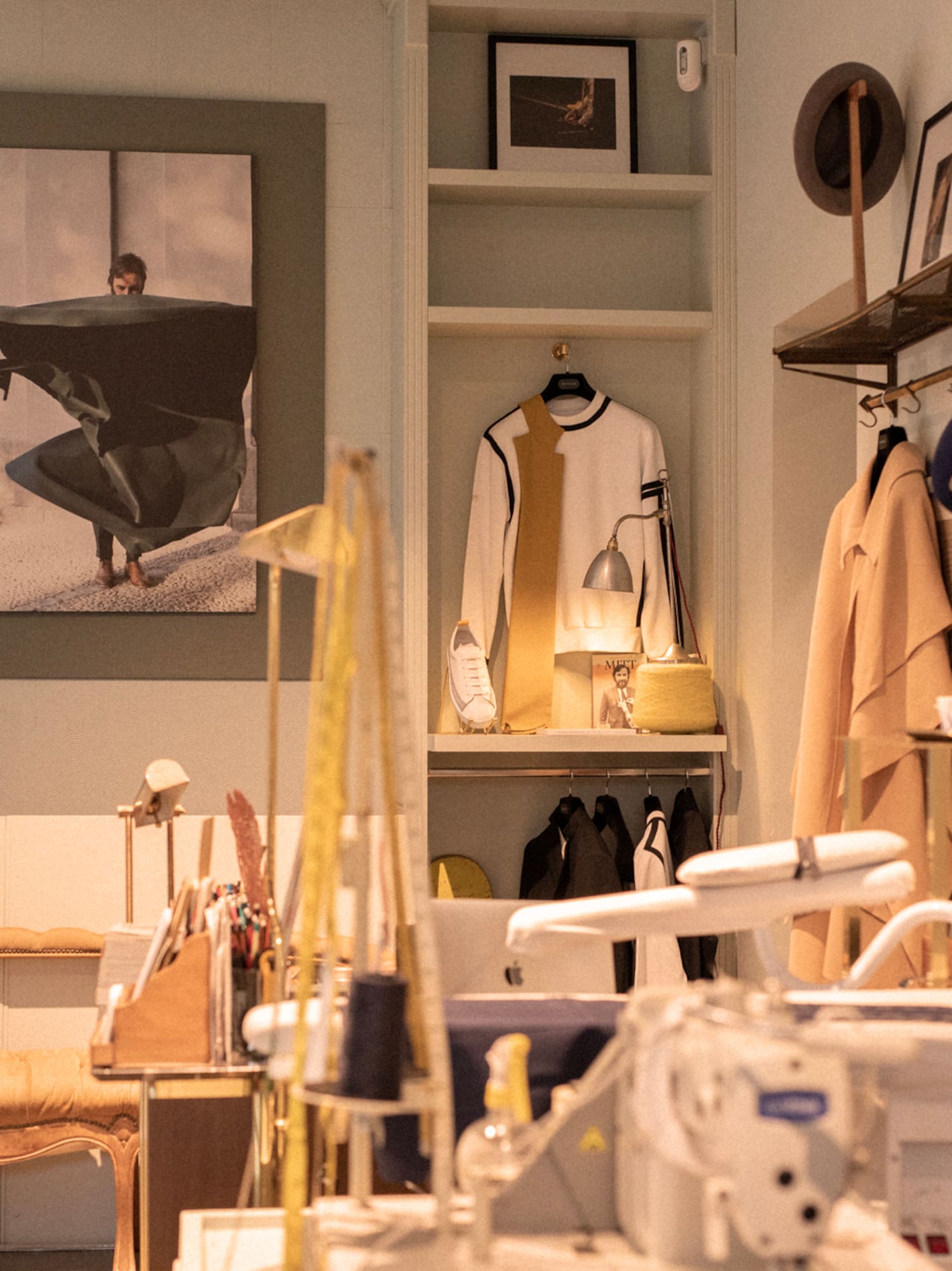 a room with a sewing machine and a picture of a man on a swinger