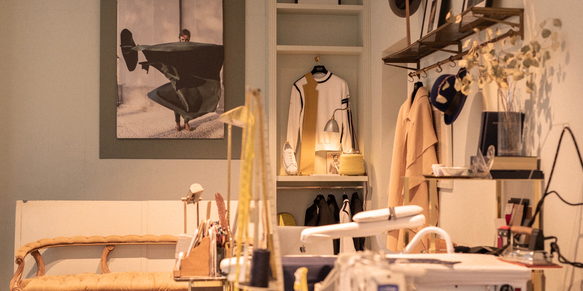 a room with a sewing machine and a picture of a man on a swinger