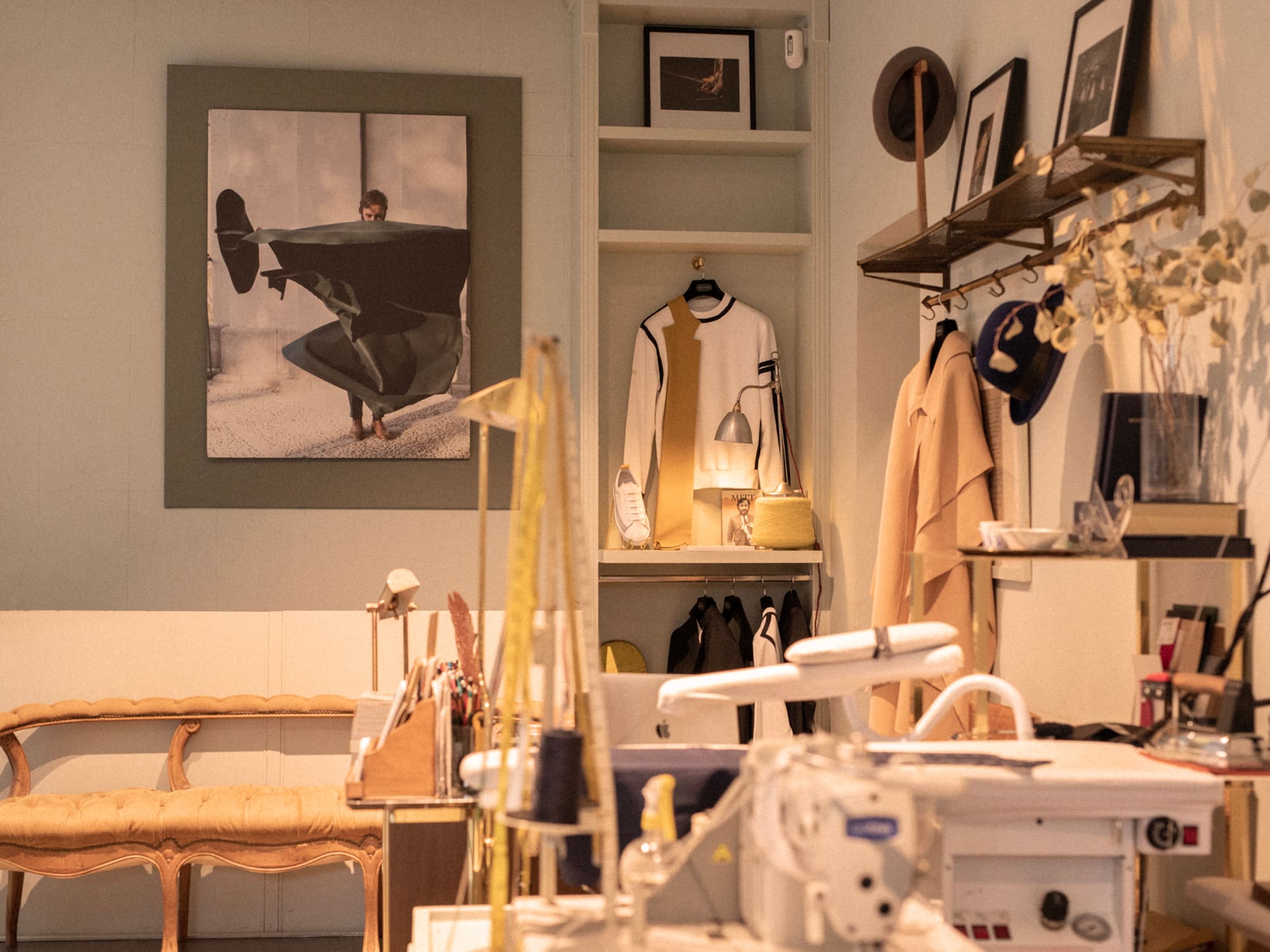 a room with a sewing machine and a picture of a man on a swinger