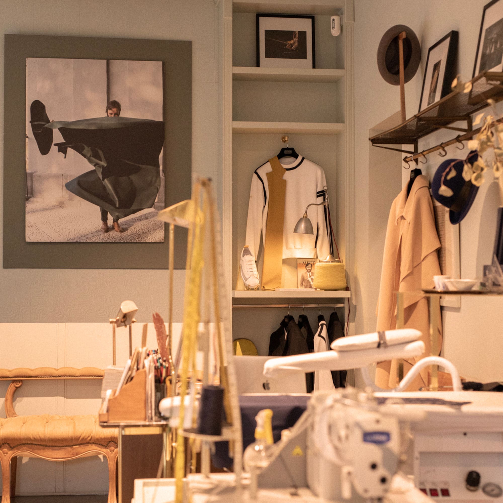 a room with a sewing machine and a picture of a man on a swinger