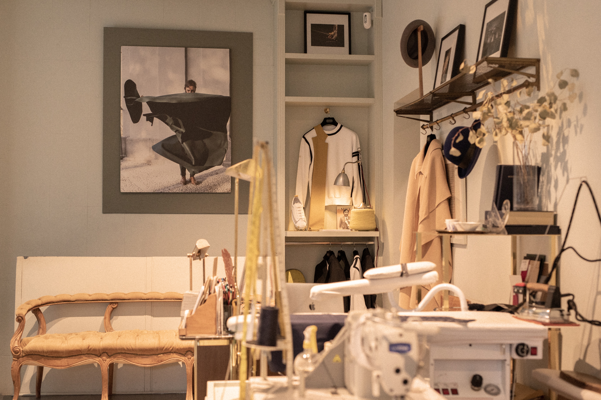 a room with a sewing machine and a picture of a man on a swinger