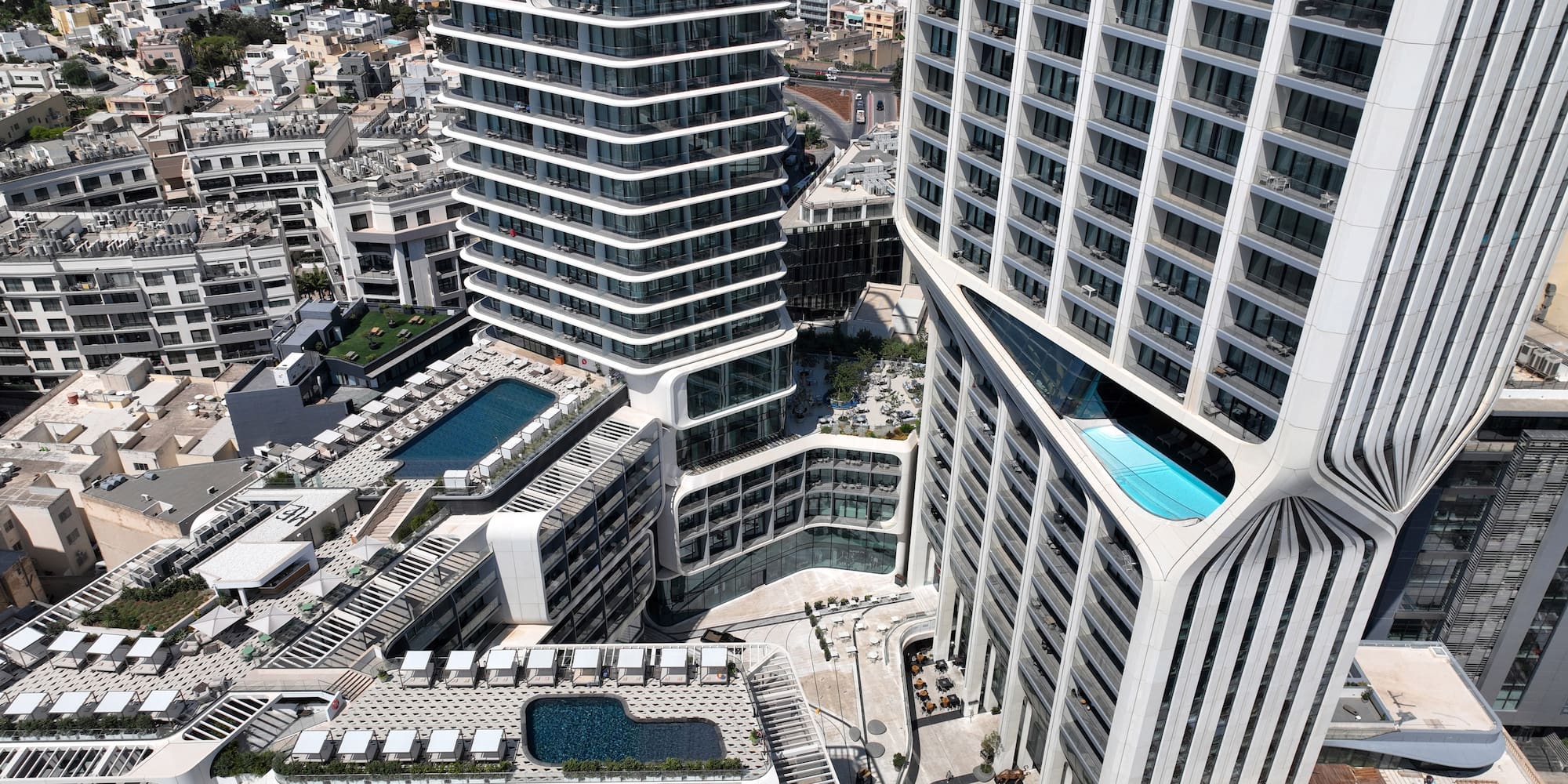 a group of buildings with a pool in the middle