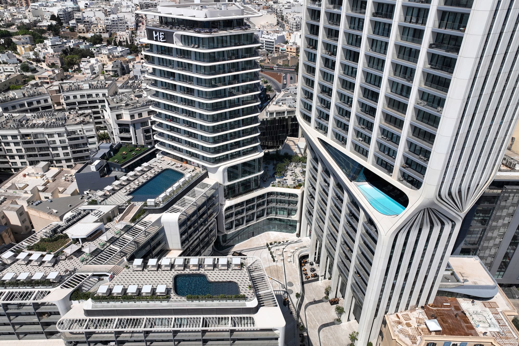 Modern urban luxury hotels with multiple rooftop and integrated pools.