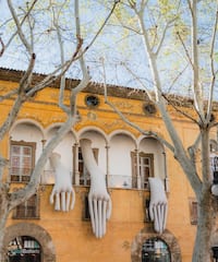 a building with white hands from the window