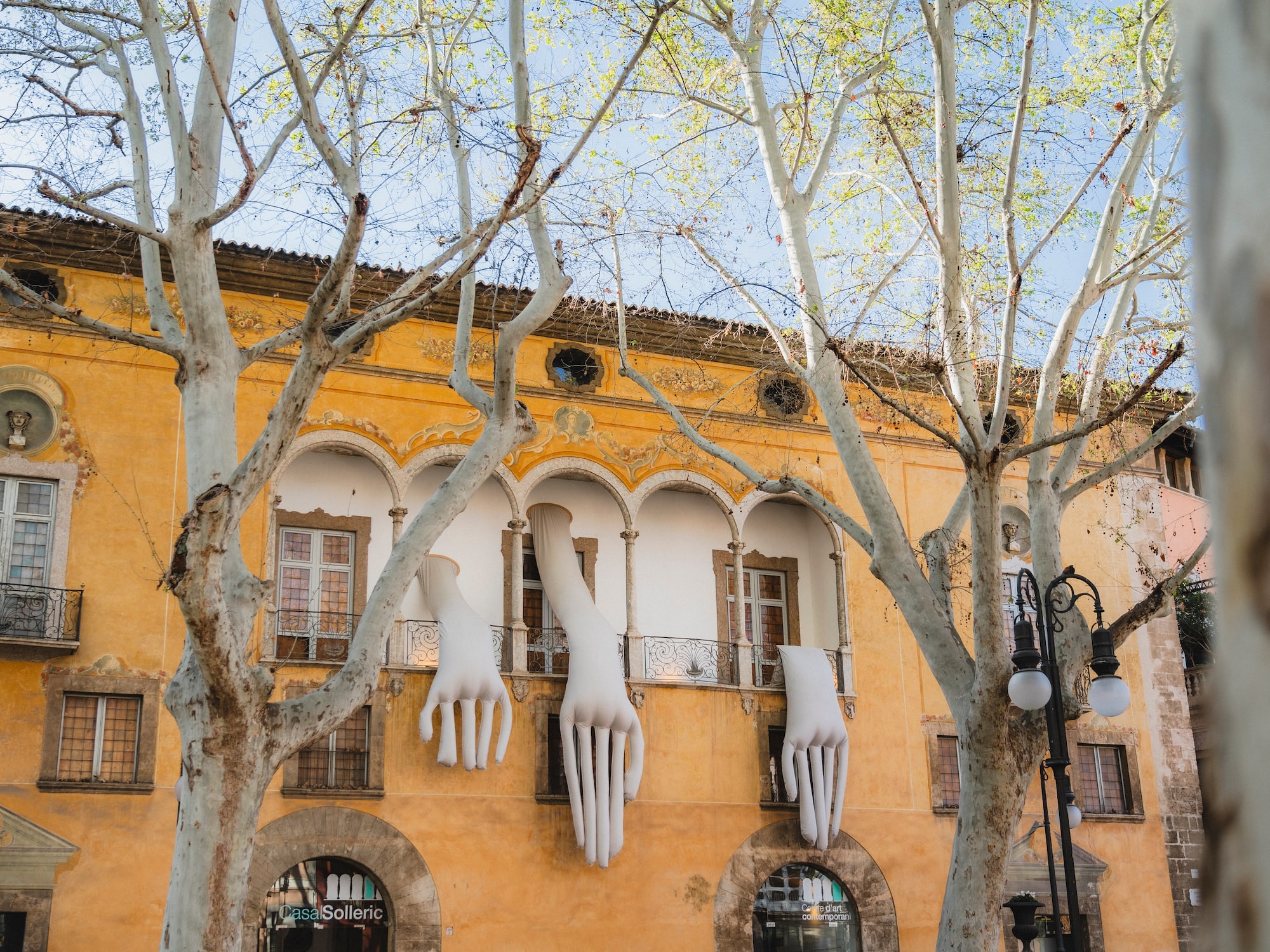 a building with white hands from the window