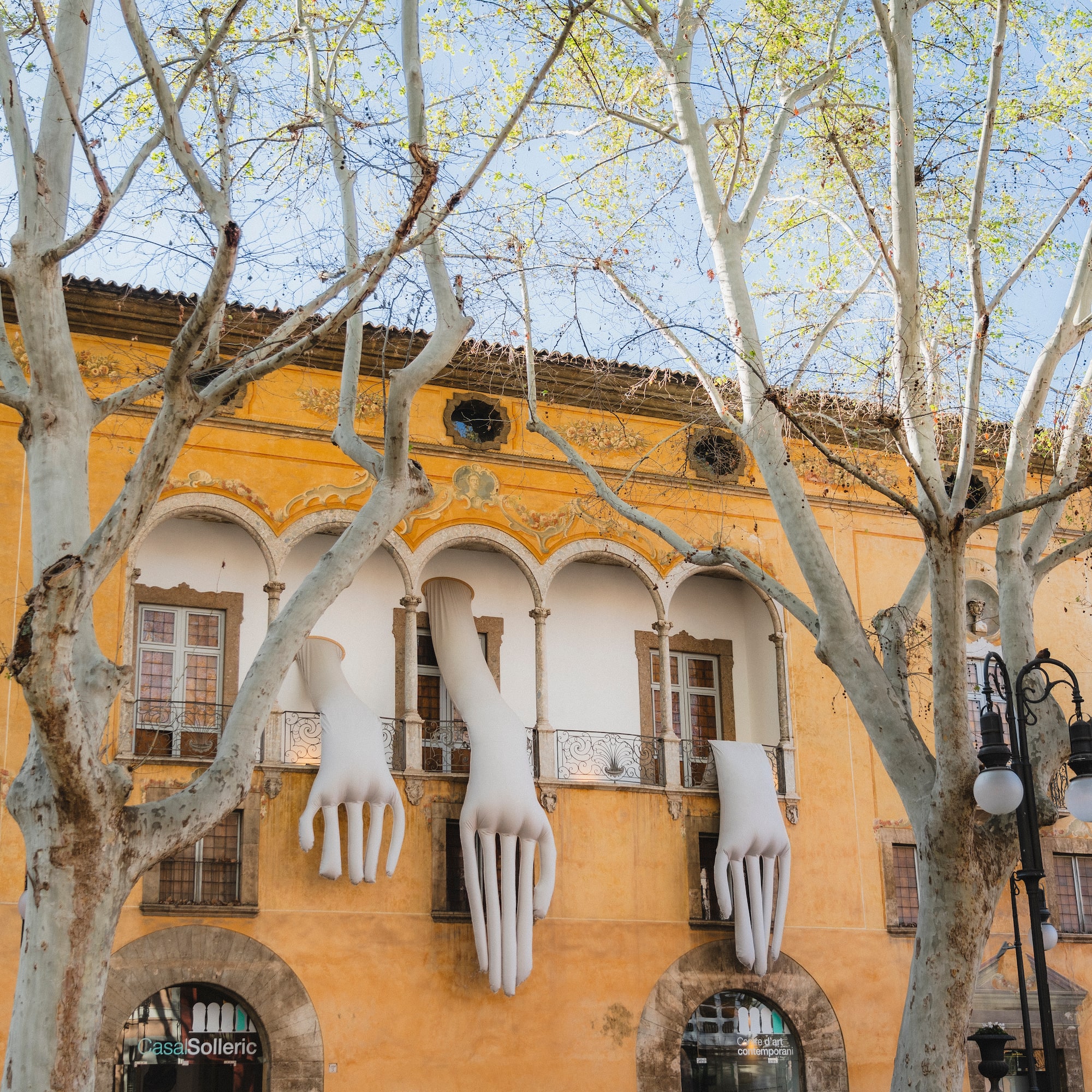 a building with white hands from the window