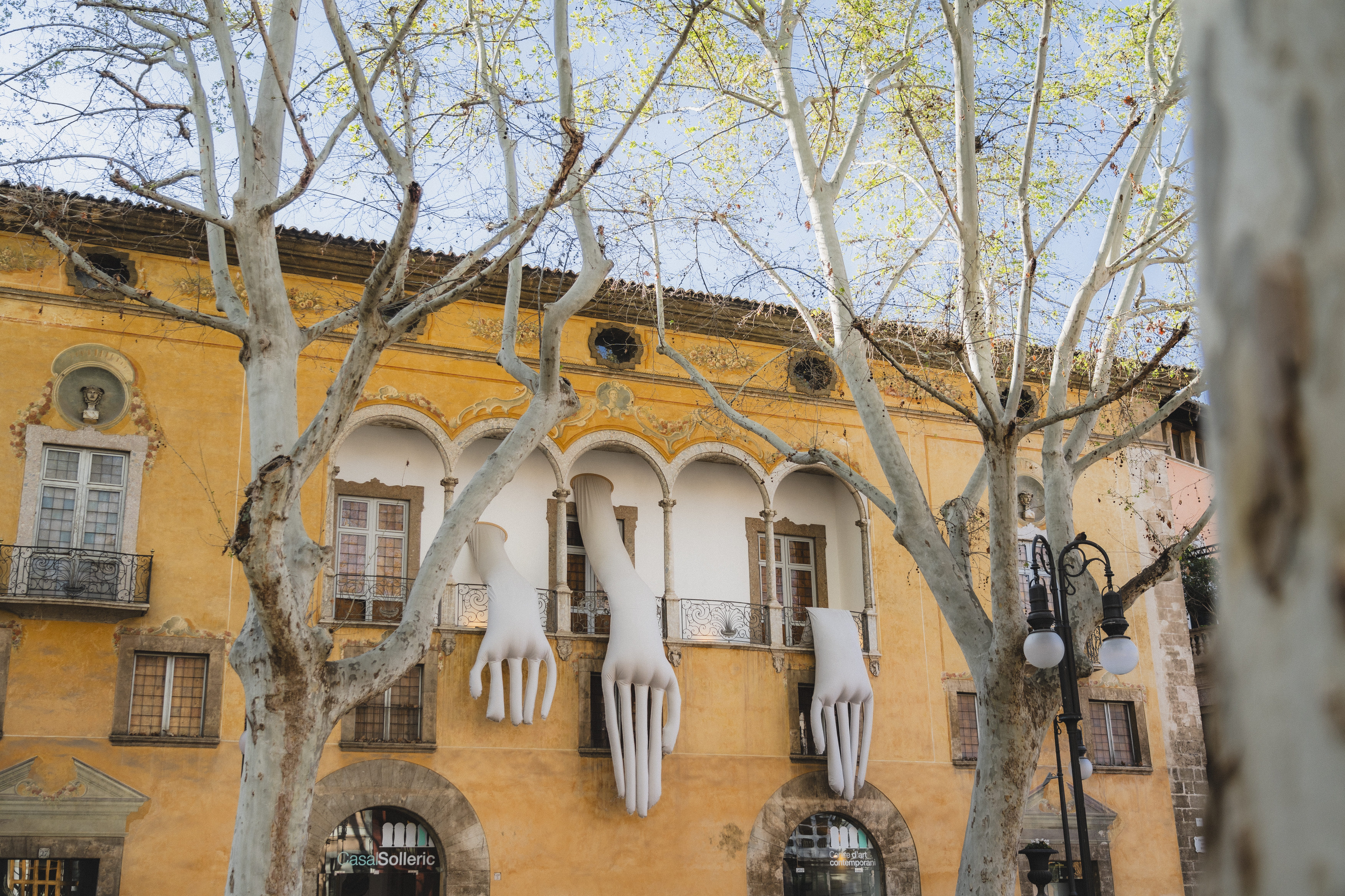a building with white hands from the window
