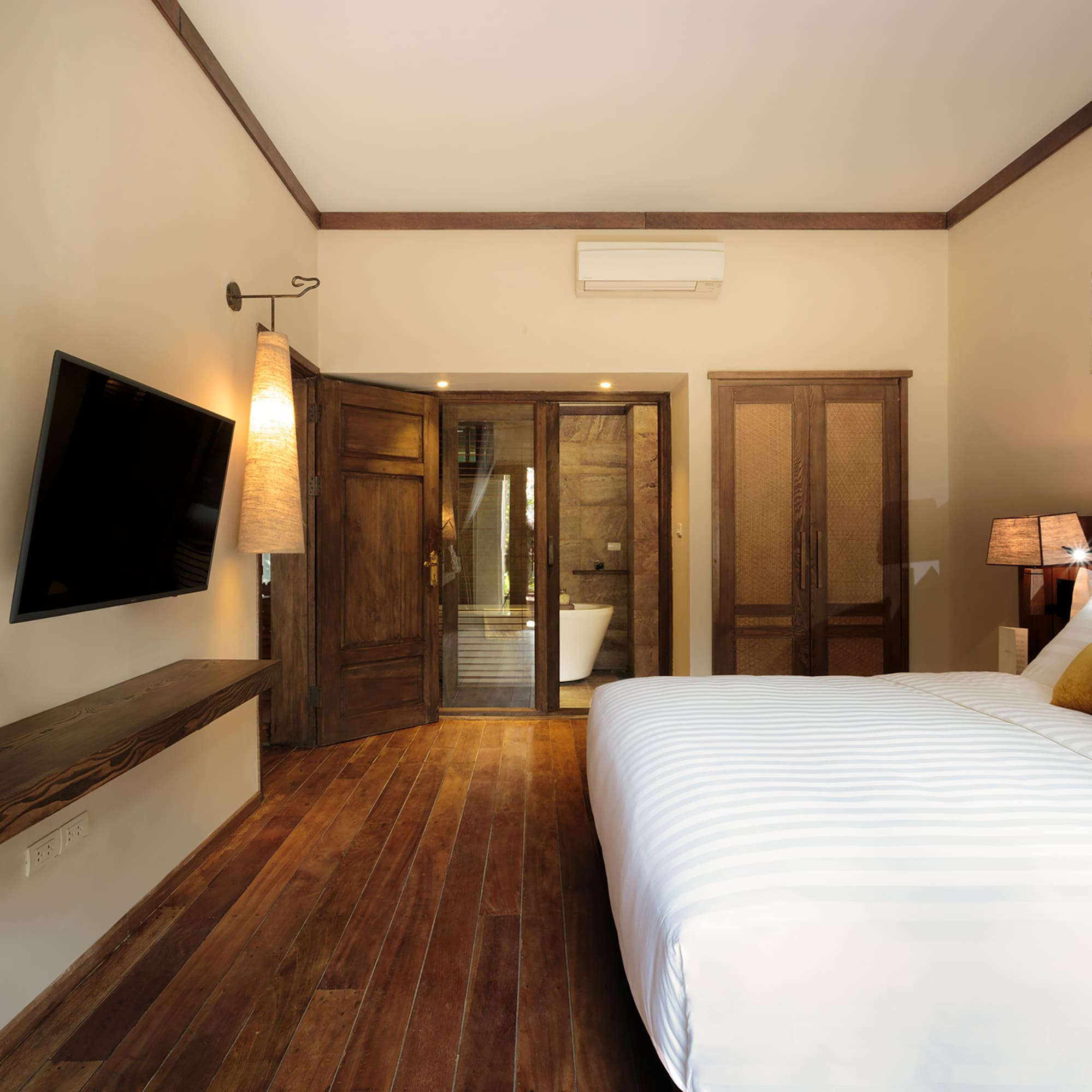 a bedroom with a large bed and a television