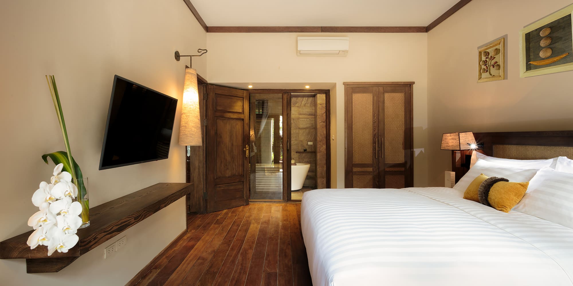 a bedroom with a large bed and a television