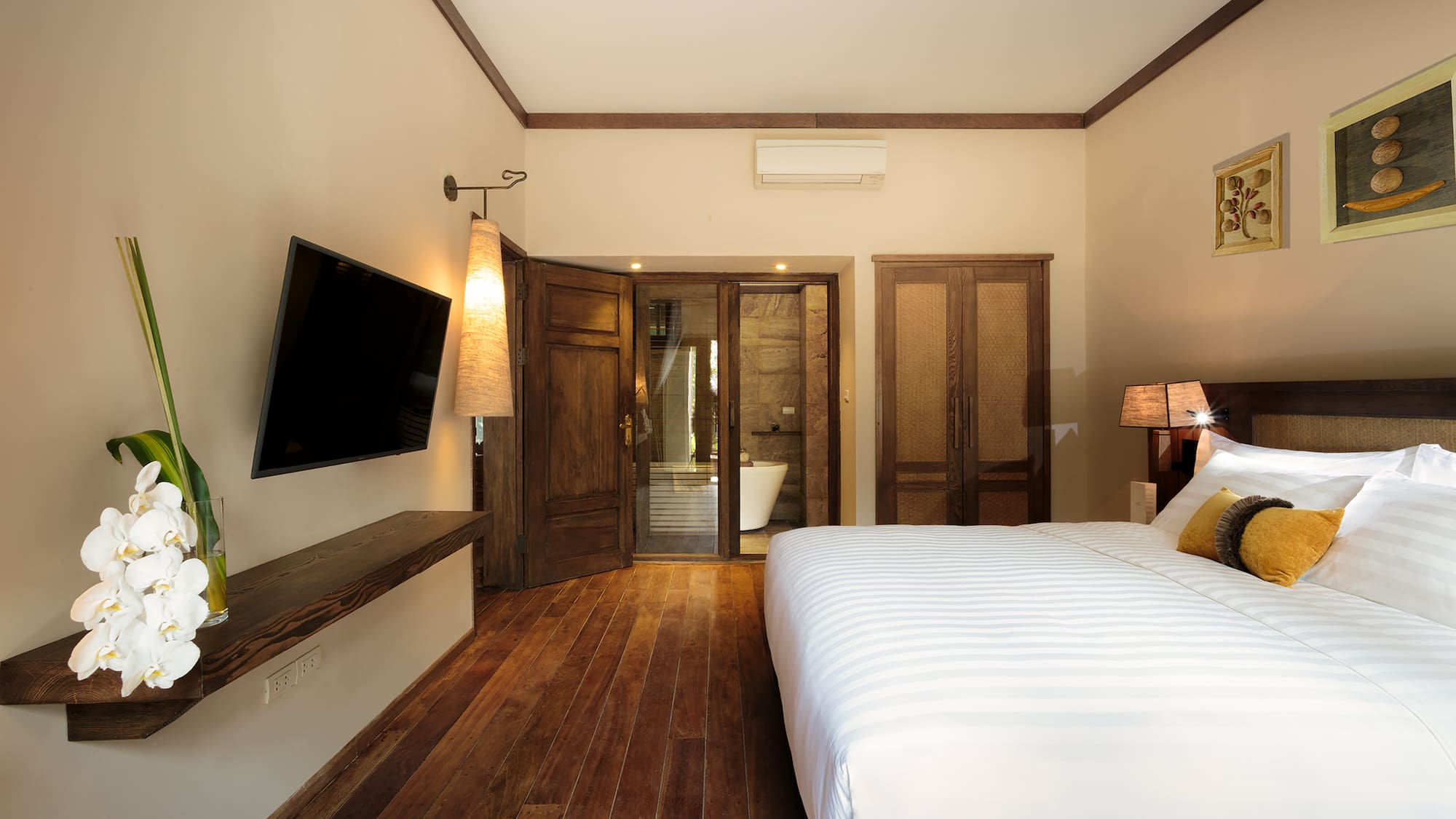 a bedroom with a large bed and a television