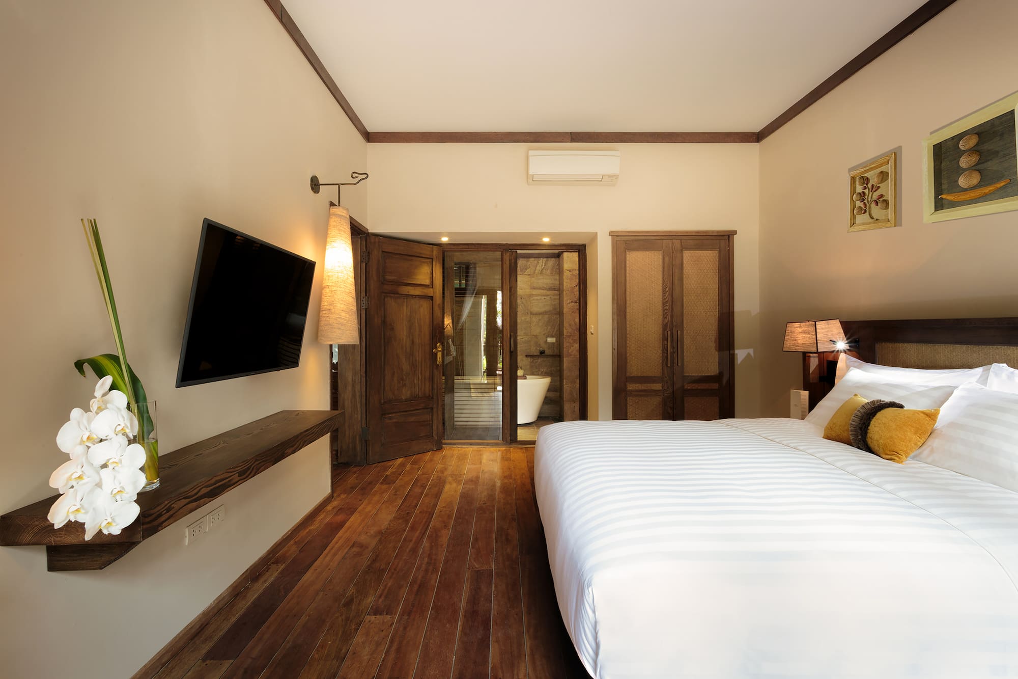 a bedroom with a large bed and a television