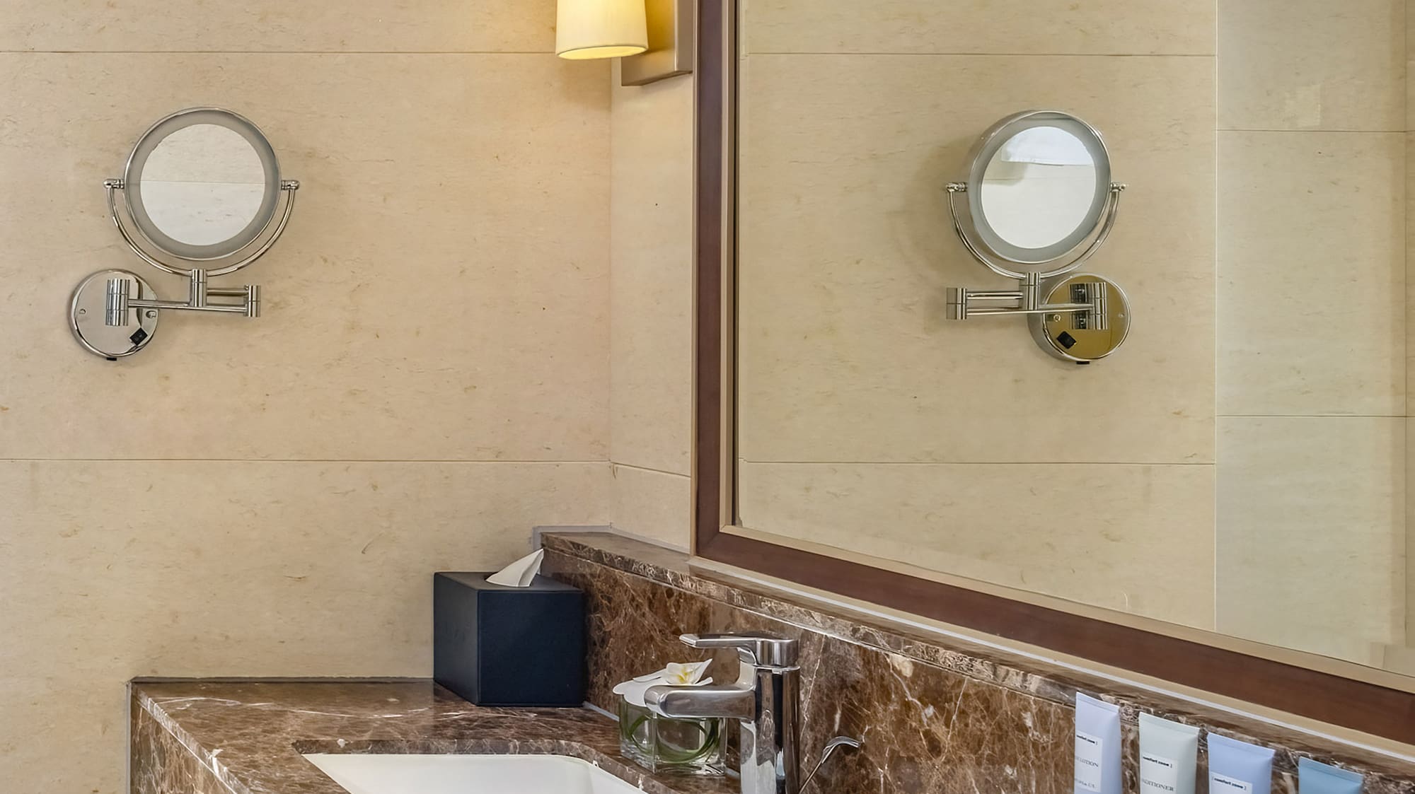a bathroom with a marble countertop and a mirror
