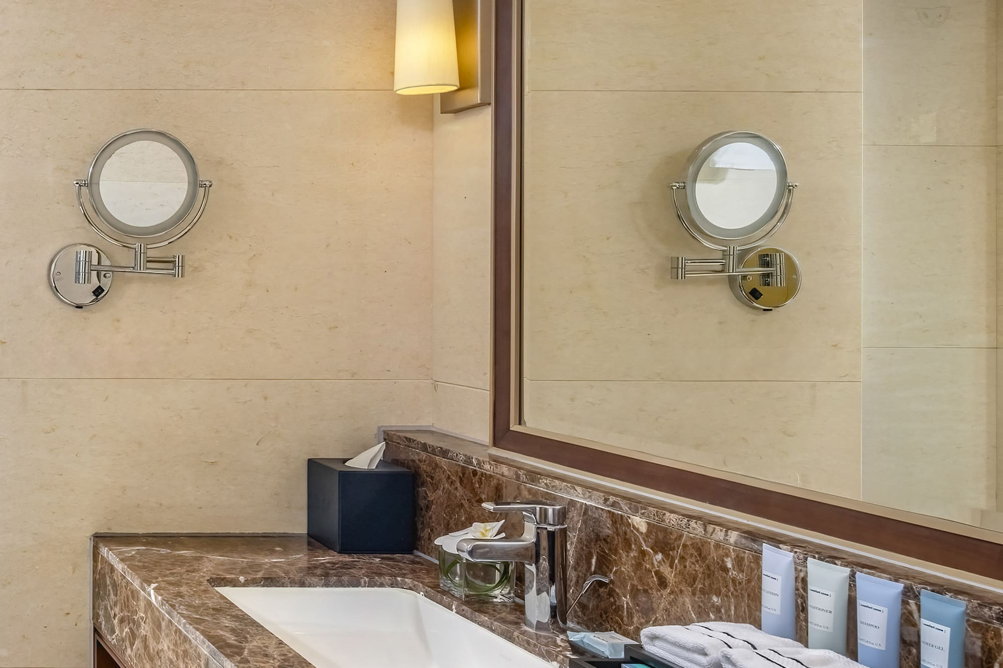 a bathroom with a marble countertop and a mirror