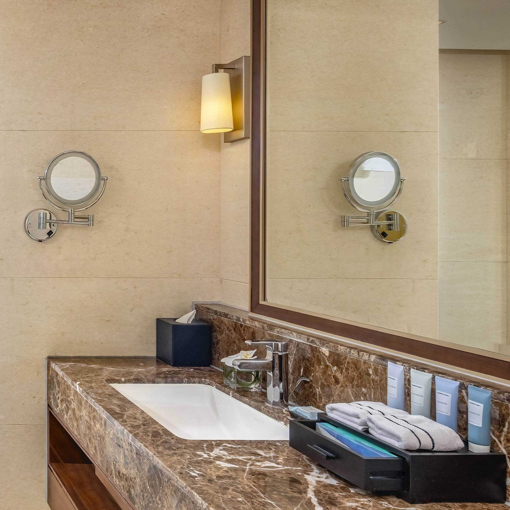 a bathroom with a marble countertop and a mirror