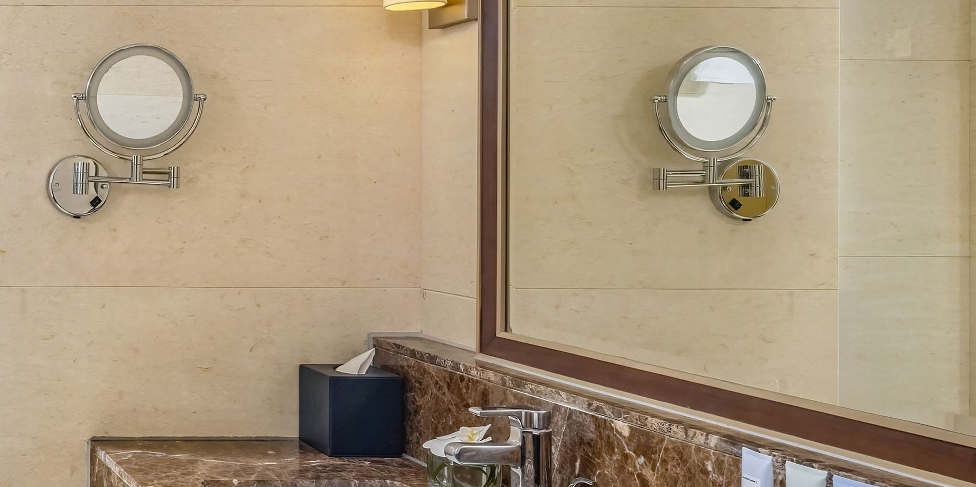 a bathroom with a marble countertop and a mirror