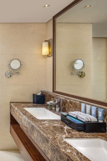 a bathroom with a marble countertop and a mirror