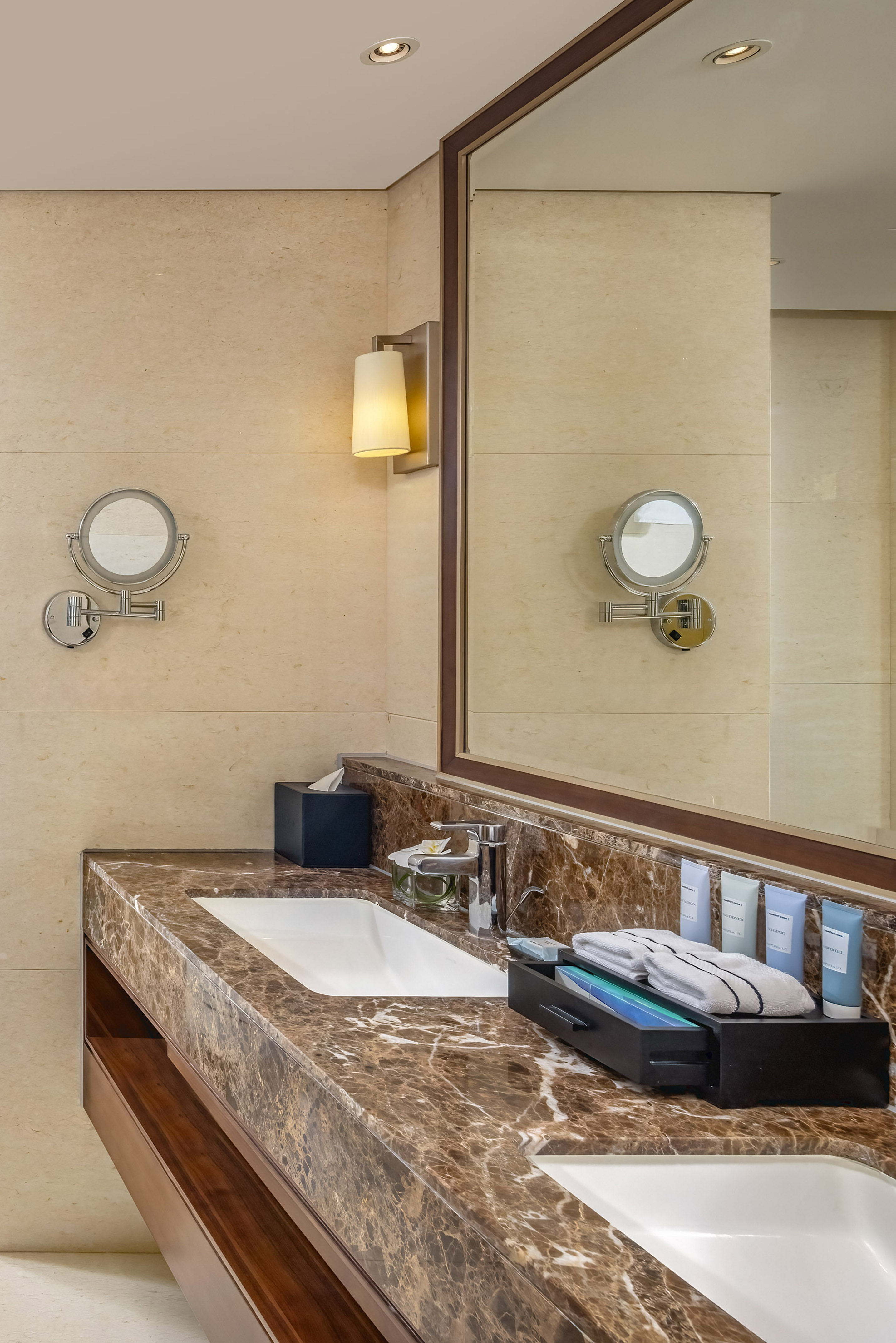 a bathroom with a marble countertop and a mirror