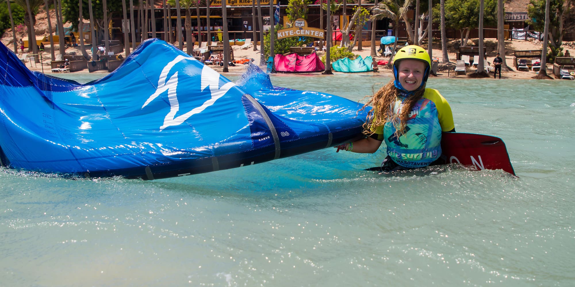 a woman holding a blue object in water
