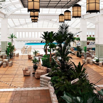 a large indoor pool with plants and chairs