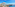 Rooftop terrace with lounge chairs, umbrellas, turquoise sea view, and coastal resort.