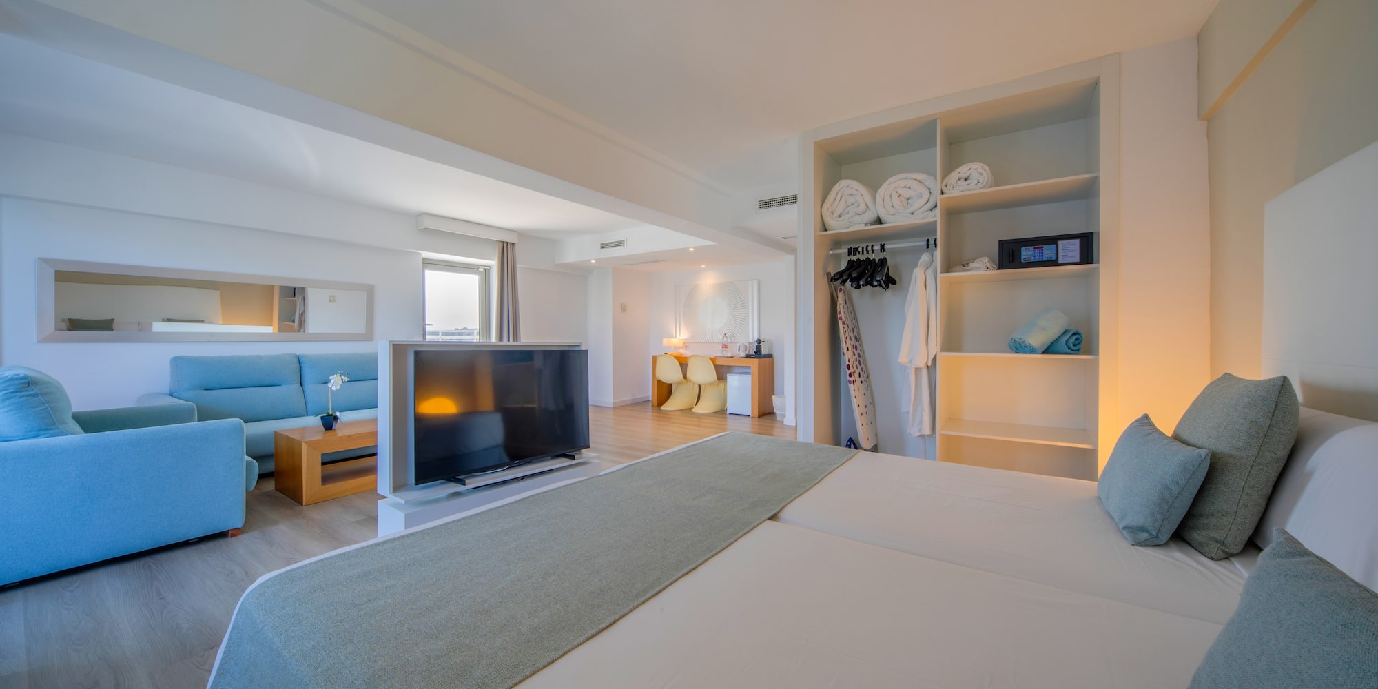 a room with a bed and a tv