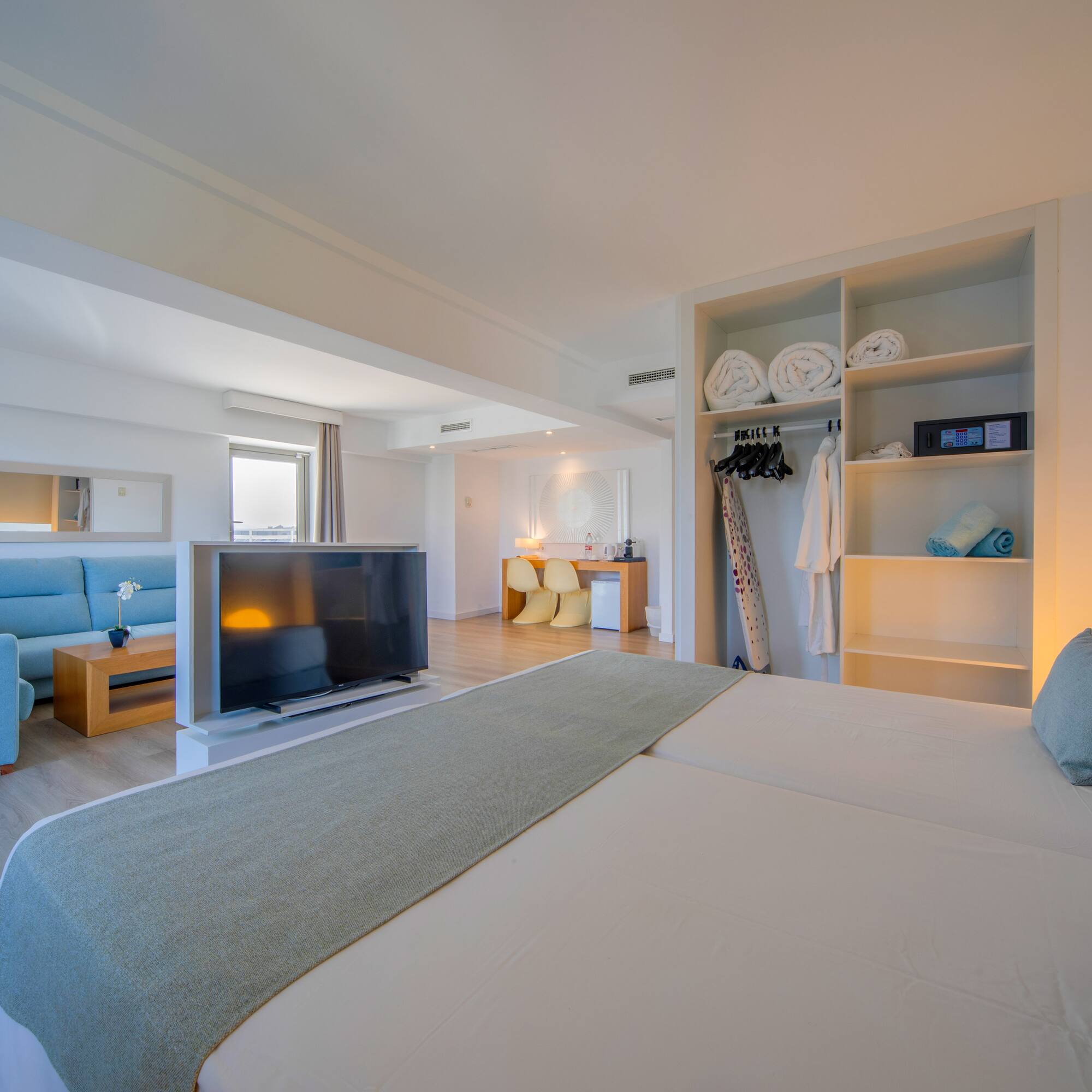 a room with a bed and a tv