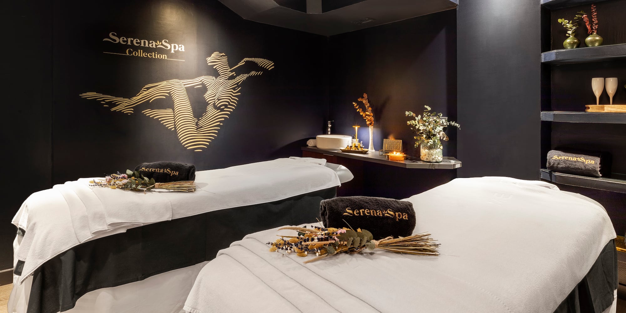 a room with two beds and a black wall