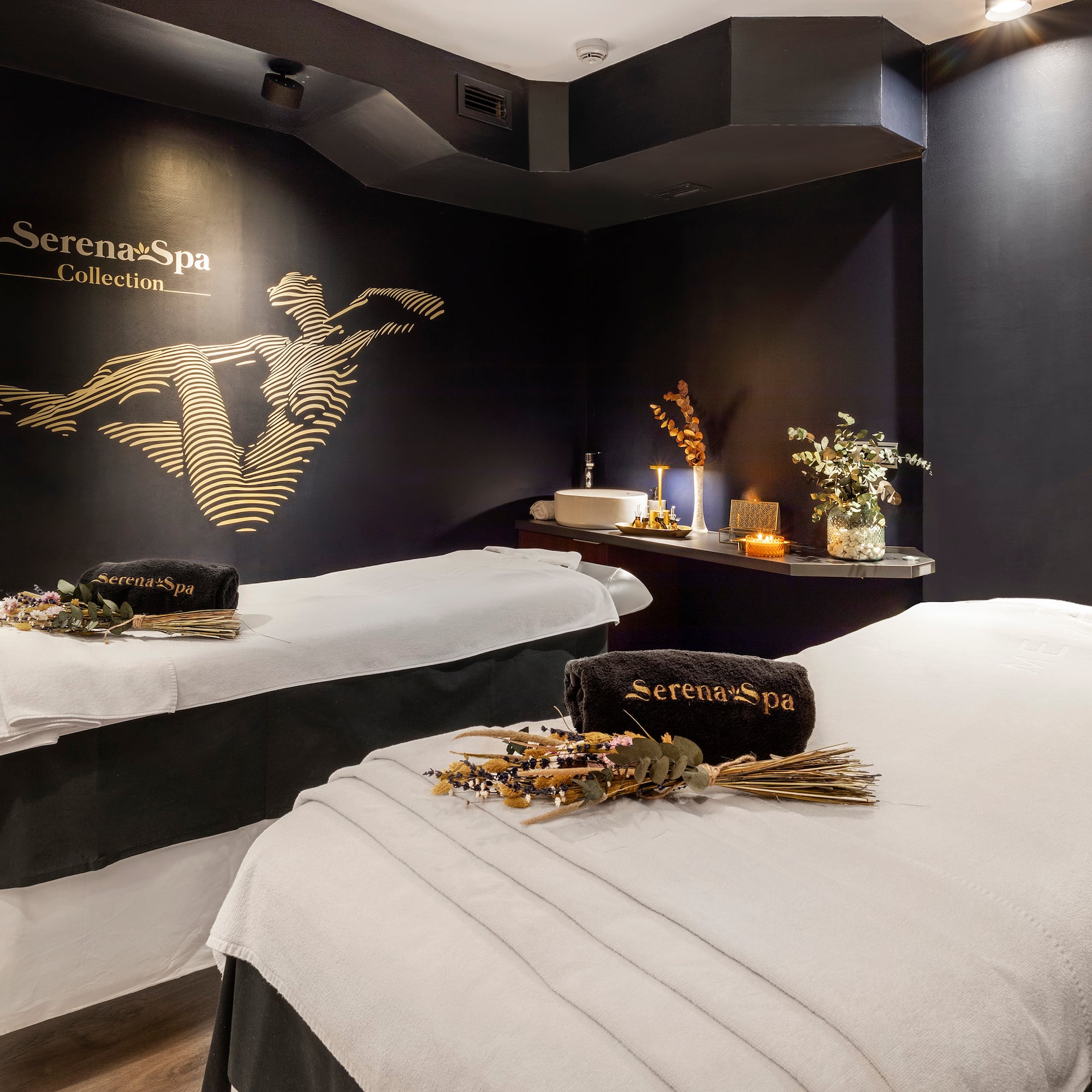 a room with two beds and a black wall