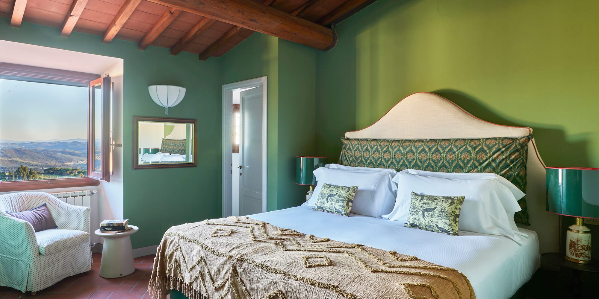 a green bedroom with a bed and a green wall