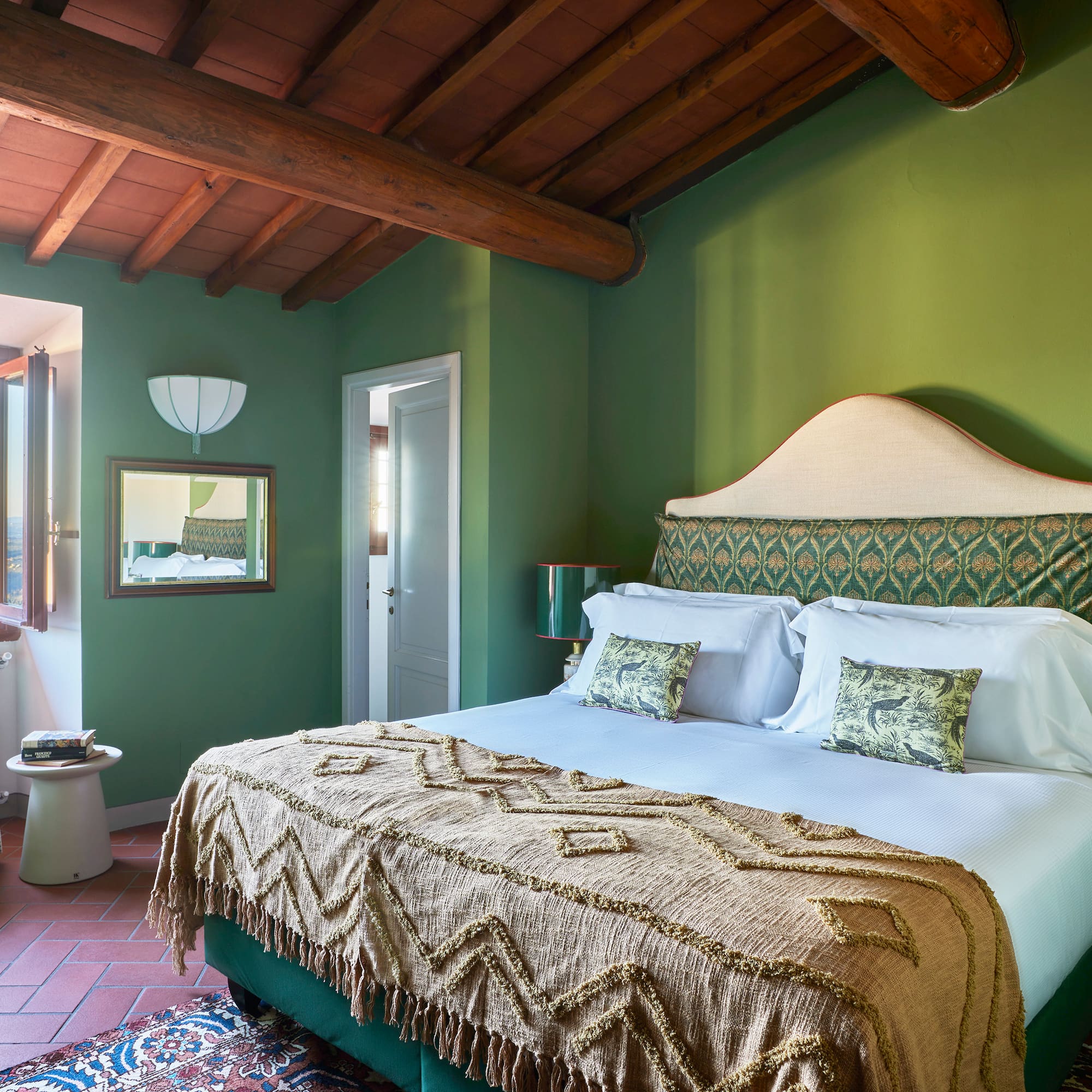 a green bedroom with a bed and a green wall