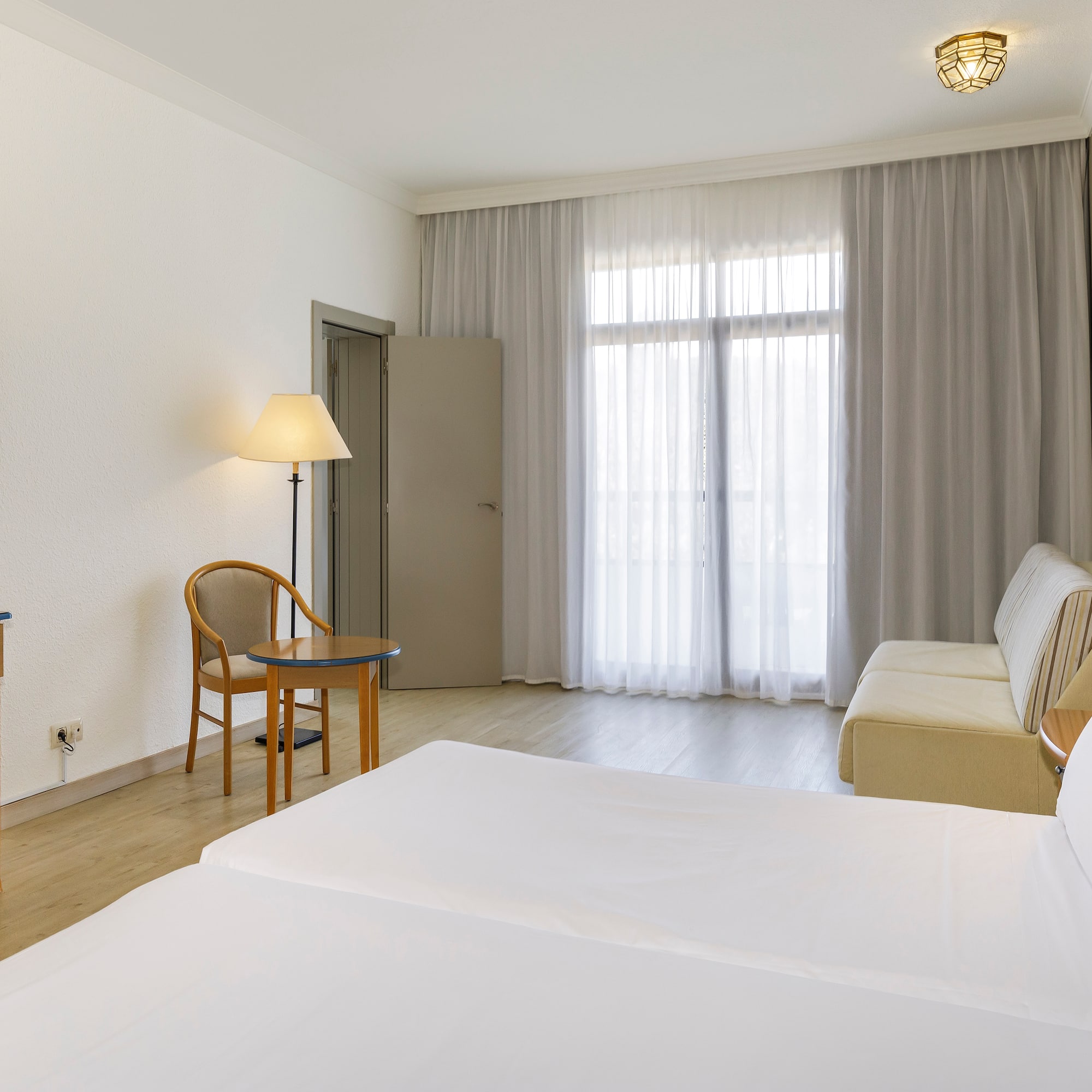 a room with two beds and a desk and a chair