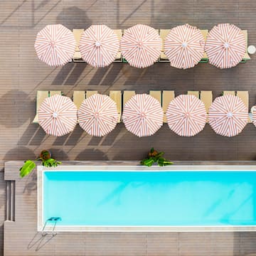 a pool with umbrellas and chairs