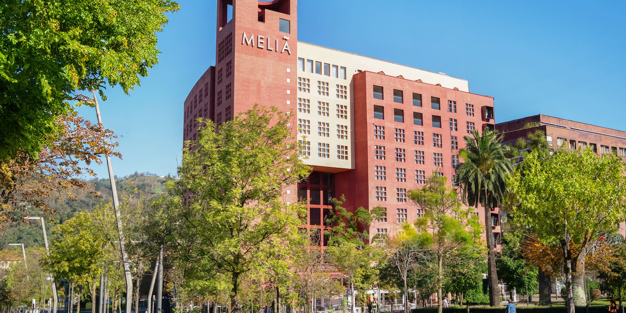 a large building with trees in front of it