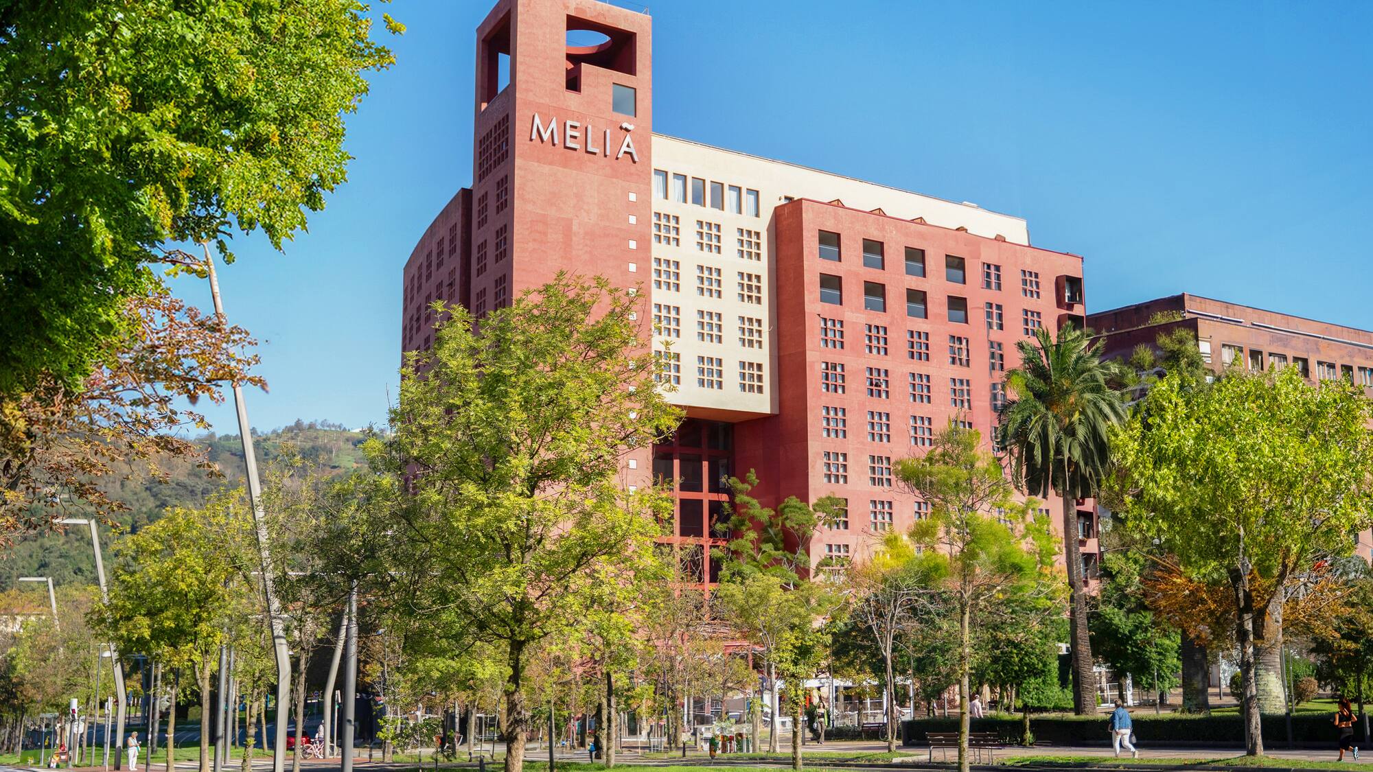 a large building with trees in front of it